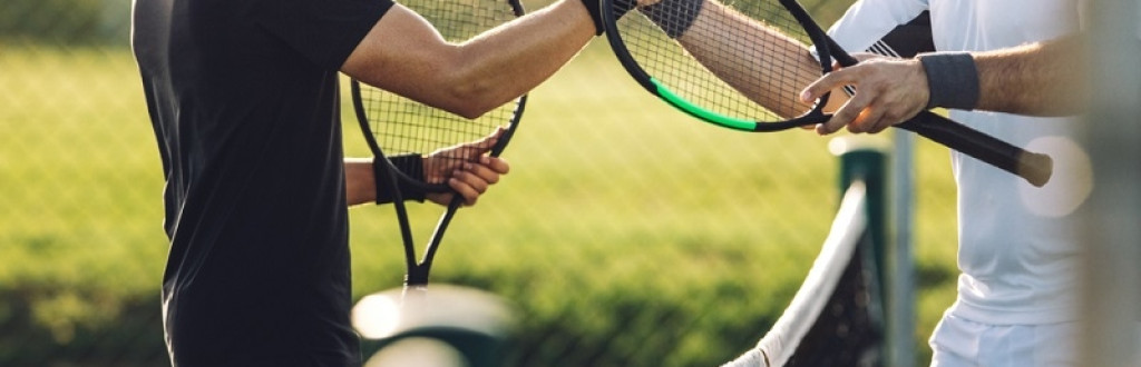 Tennis players shaking hands over the net after the match