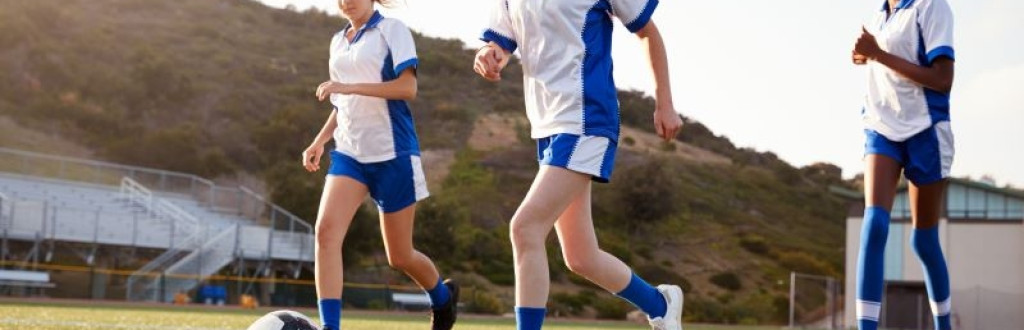 a group of female high school students playing on a soccer team, promoting social impact and equality