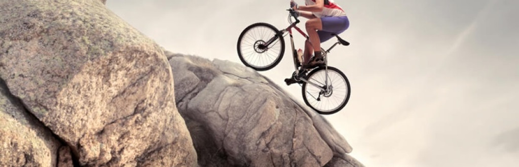 Cyclist climbing on a rock