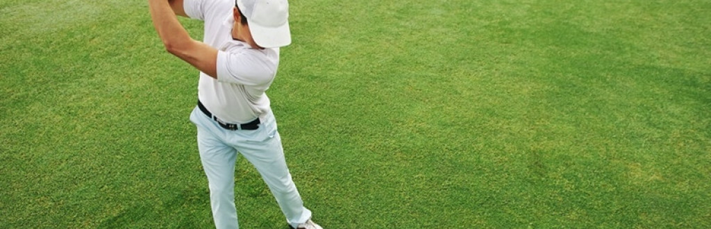 Golfer hitting golf ball