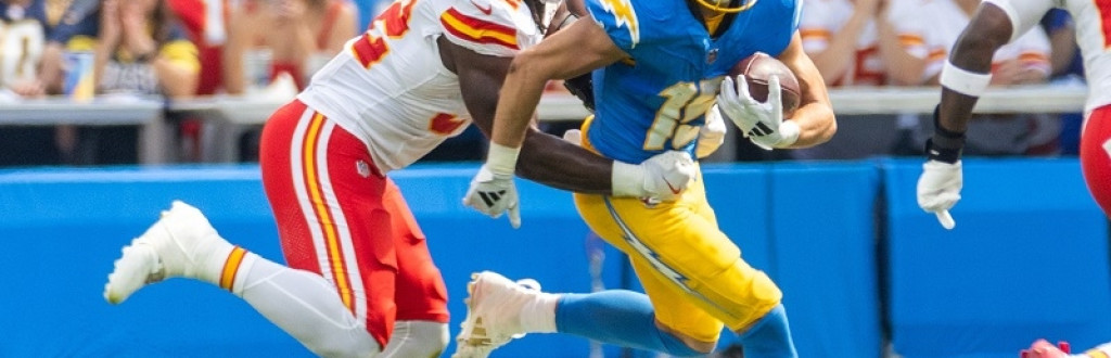LA Chargers wide receiver Ladd McConkey  runs to escape a tackle by KC Chiefs linebacker Nick Bolton #32 during an NFL football game 