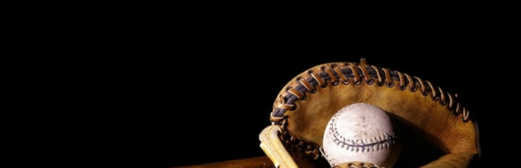 Baseball Glove with bat and ball on dark background