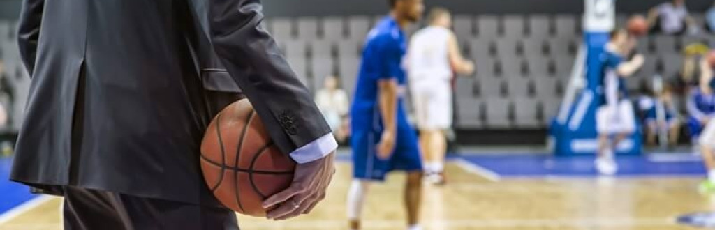 Basketball coach holding the ball in his hand