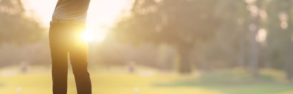 Golfer golfing in the morning sunlight