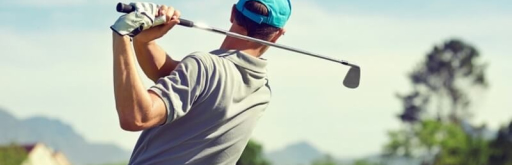 Golfer hitting golf shot with club
