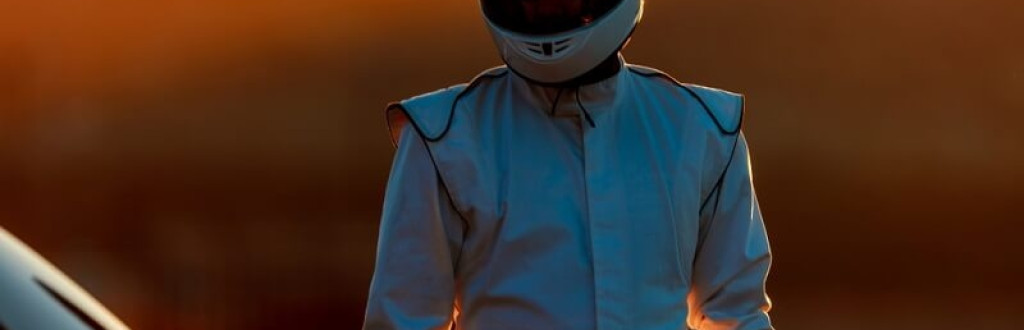 Race Car Driver wearing while helmet and  racing suit