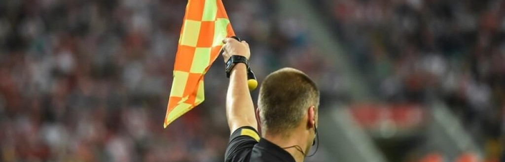 Soccer referee raising the flag Indicating off-side