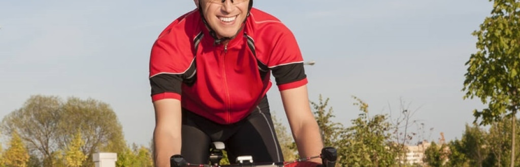 Smiling Caucasian Road Cyclist During Ride on Bike 