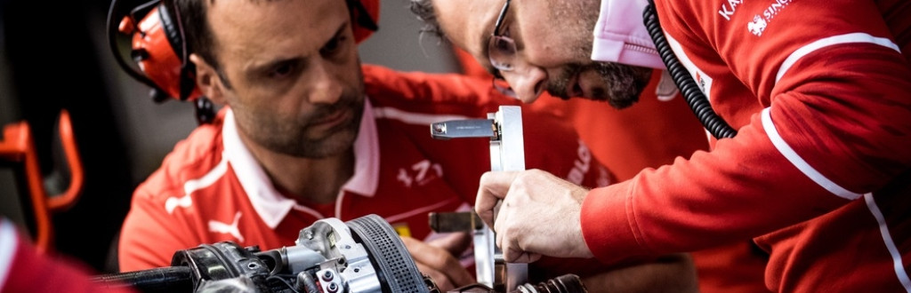 Racing engineers of Scuderia Ferrari F1 Team working with brakes at Formula One